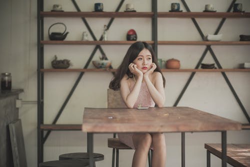 Woman sitting on a wooden table